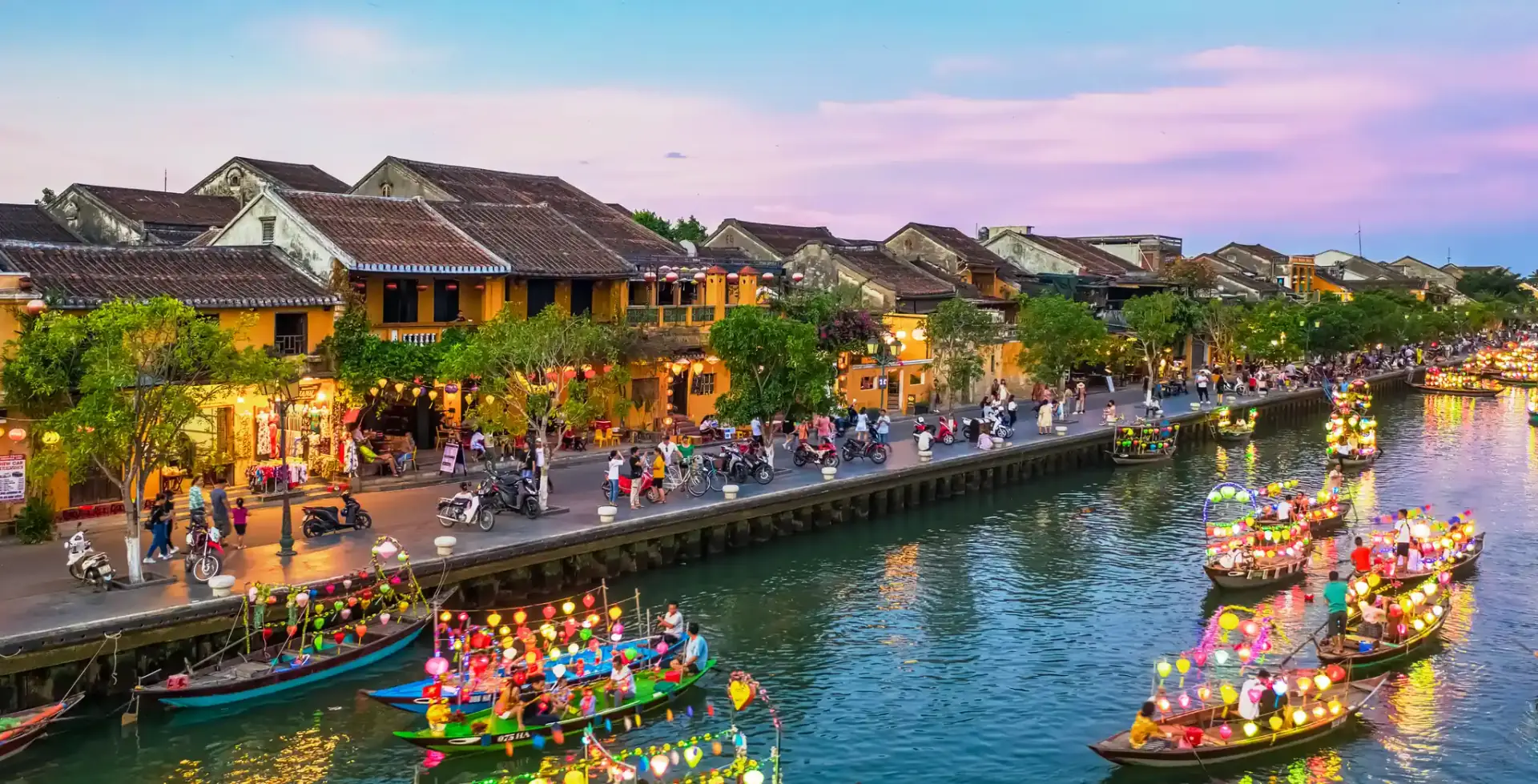 Hoi An ancient town riverside with lantern boats at dusk, Vietnam