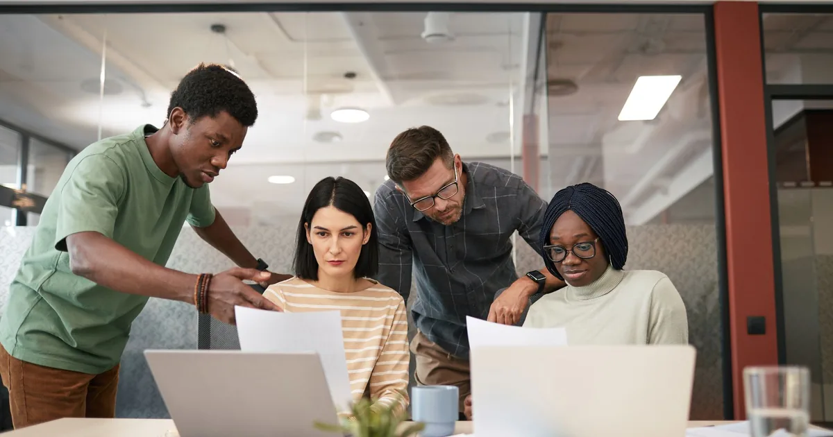 Diverse team localizes content, driving conversions in a modern office.