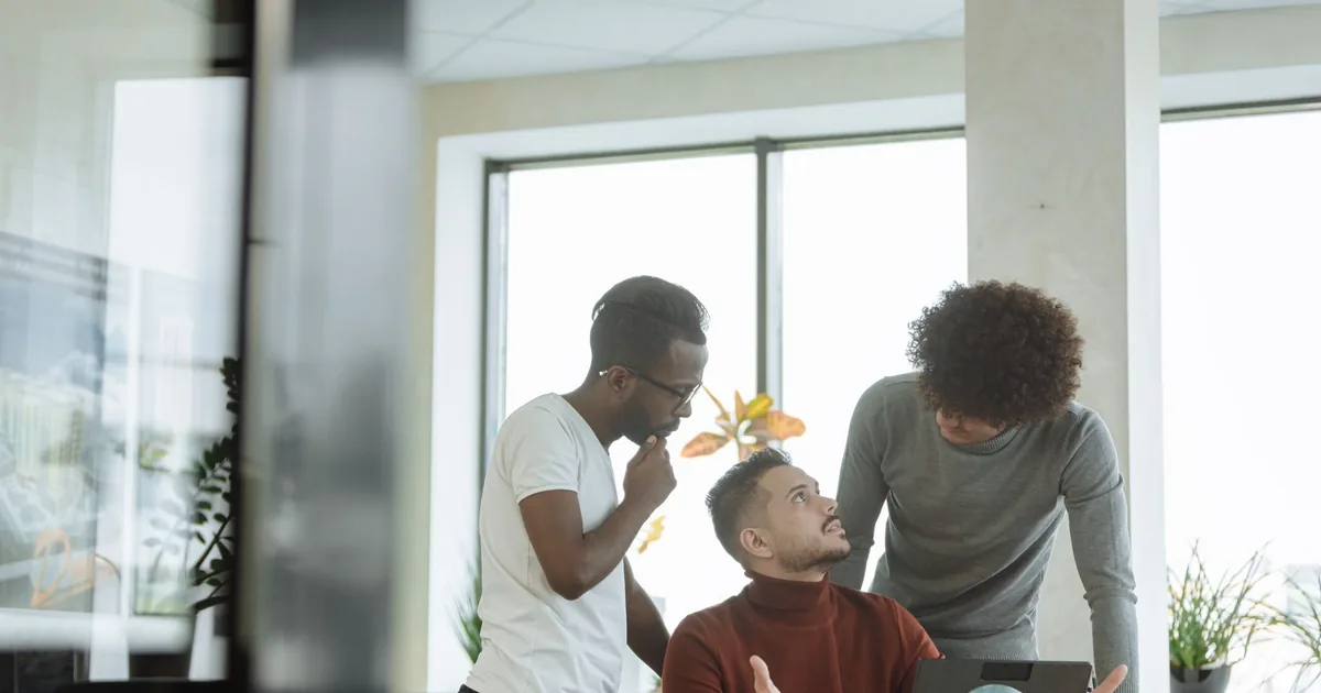 Diverse male colleagues discuss internationalization vs localization strategies.