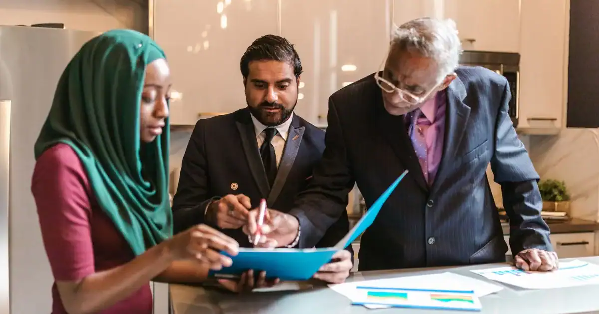 Diverse business team collaborating on a project in a stylish, modern office setting. - FAS Localize