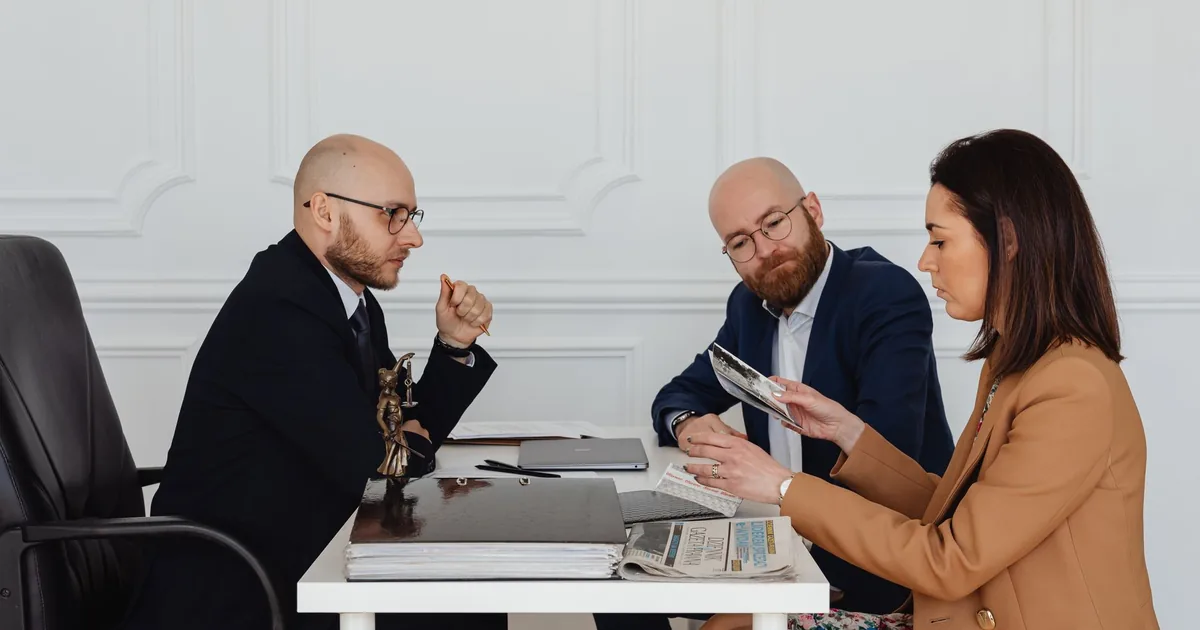 Professionals reviewing documents, weighing Übersetzungsbüro vs Freelancer for contracts.