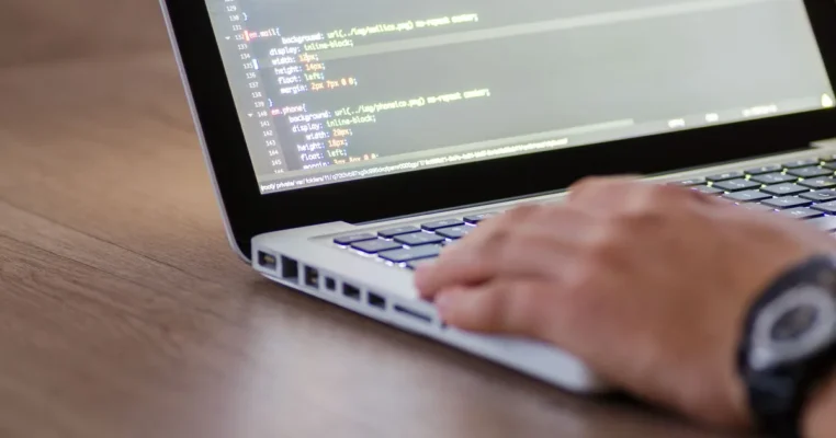 HTML code on screen as a person works, illustrating what is MTPE.