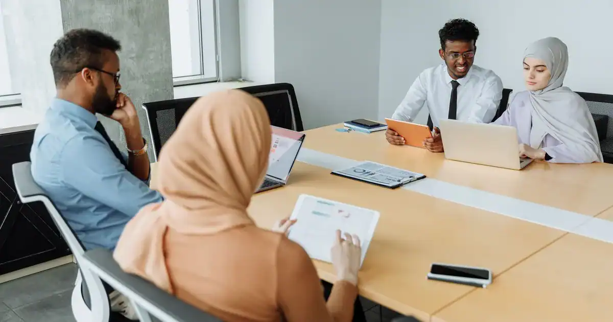 A diverse group of professionals having a meeting in a modern office setting, showcasing teamwork an