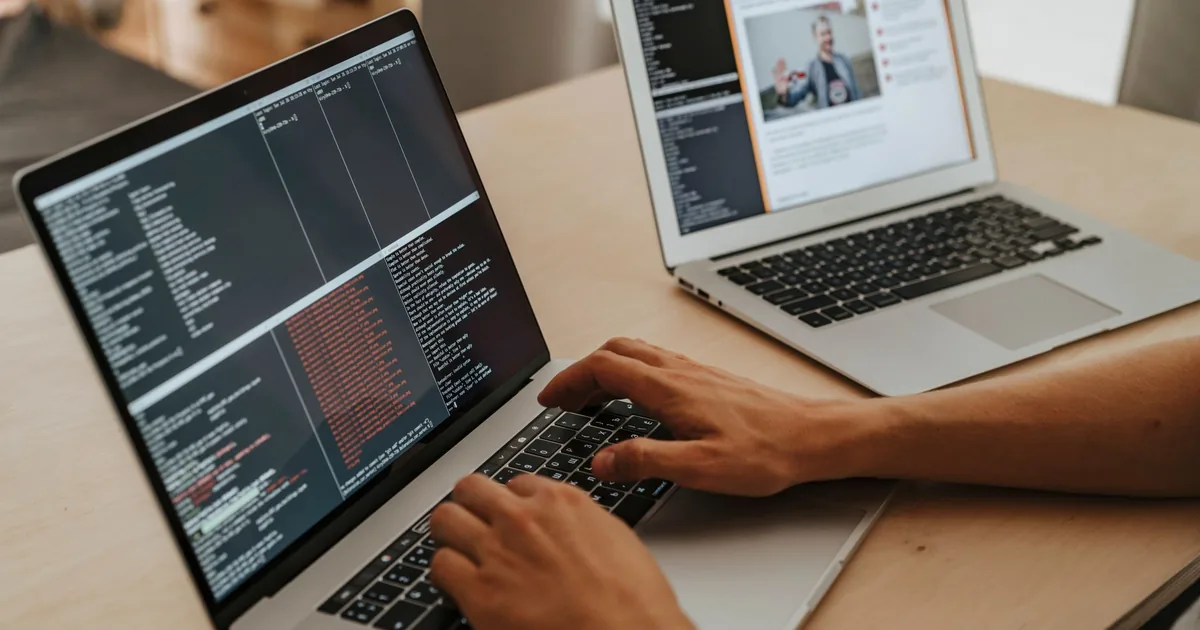 A developer working on a laptop, typing code, showcasing programming and technology skills. - FAS Lo