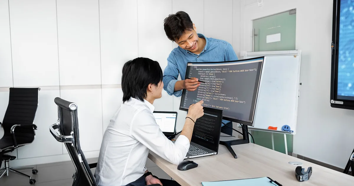 Two pros collaborate, ensuring quality through localization testing.