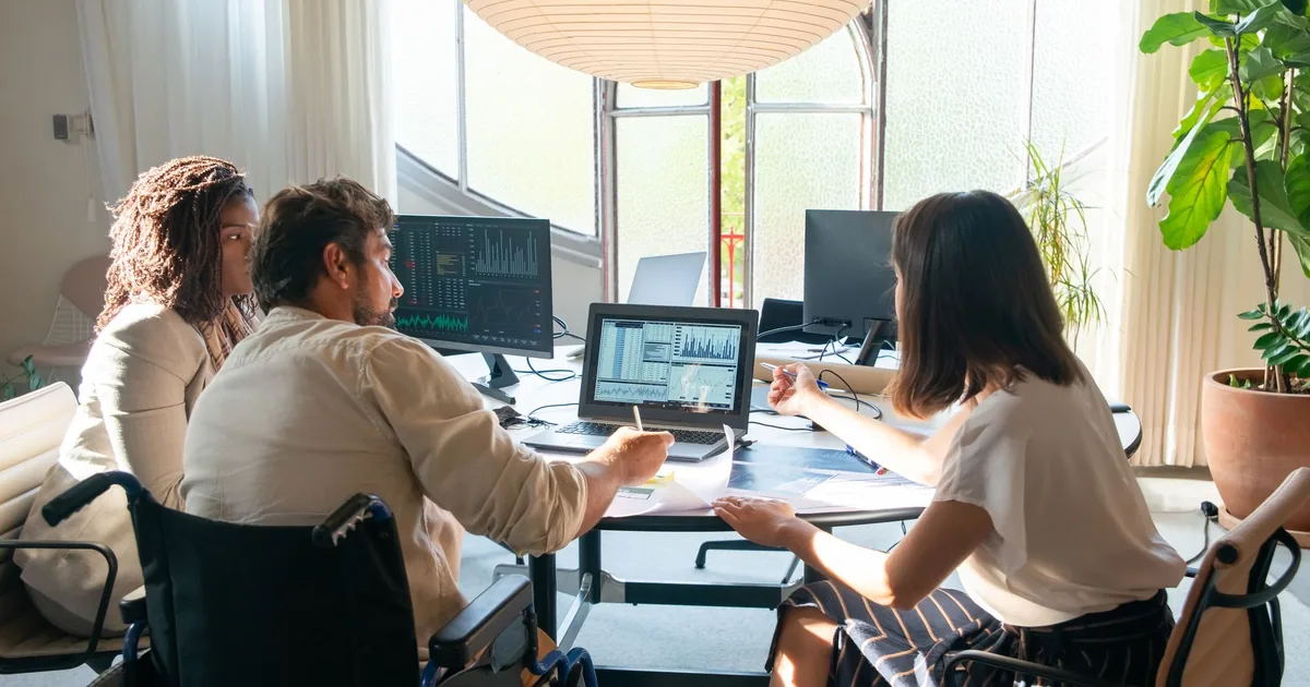 Diverse team discusses charts, choosing the best speech data vendor for SEA.