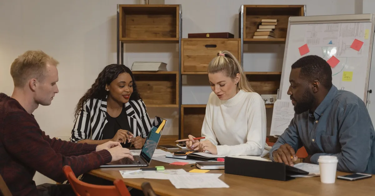 Multicultural team discusses localization project management strategies.