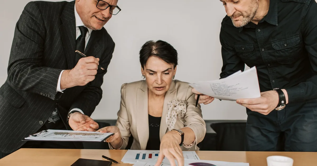 Team collaborates on financial strategies, ensuring smooth localization project management.