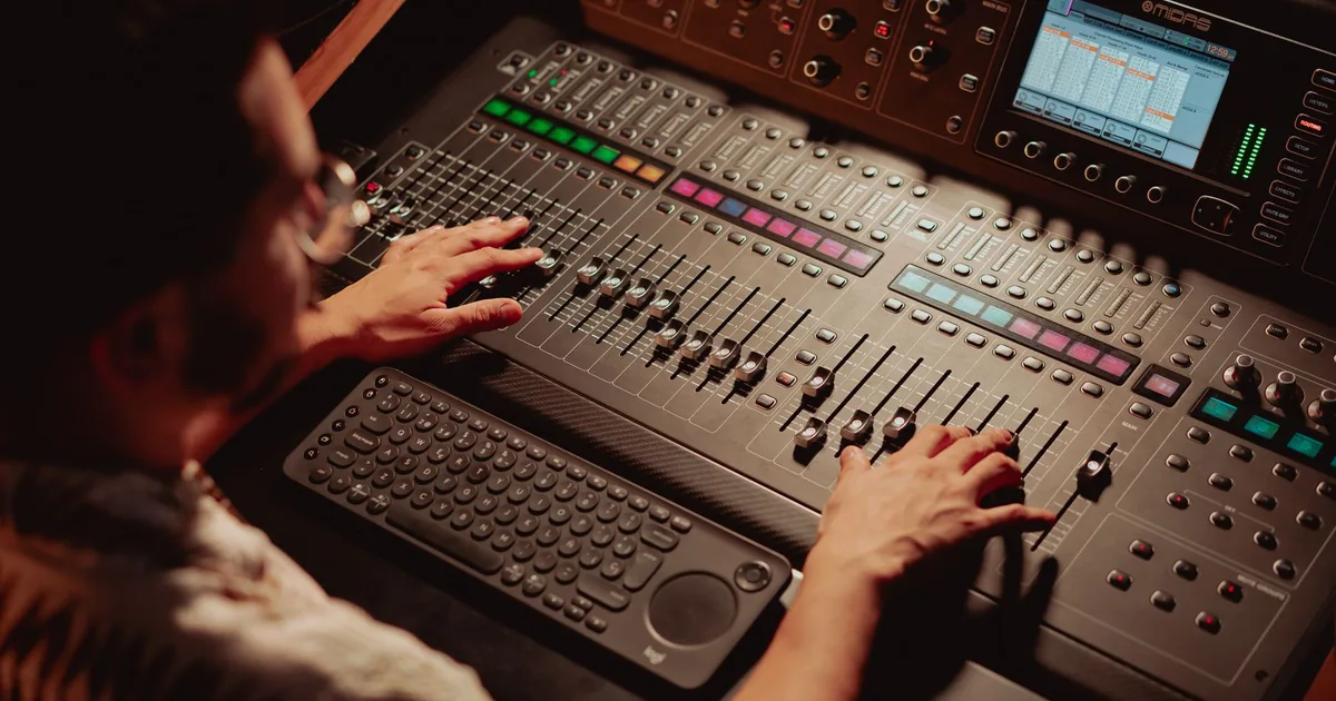 Audio engineer mixing sound, essential for subtitling vs voiceover.